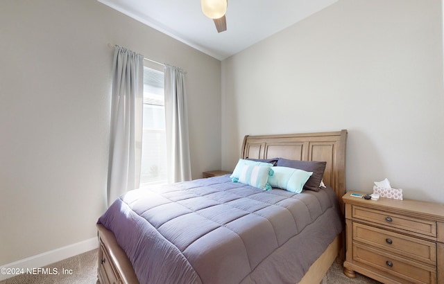 carpeted bedroom with vaulted ceiling and ceiling fan