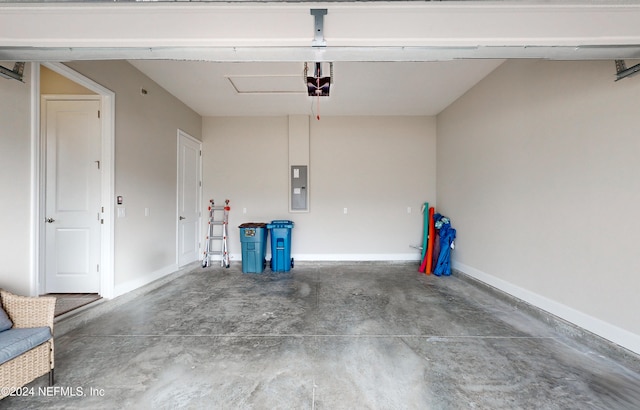 garage with a garage door opener and electric panel