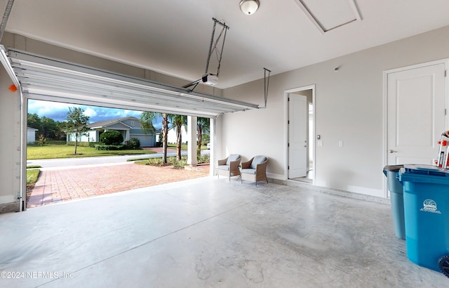 garage with a garage door opener, a lawn, and a carport