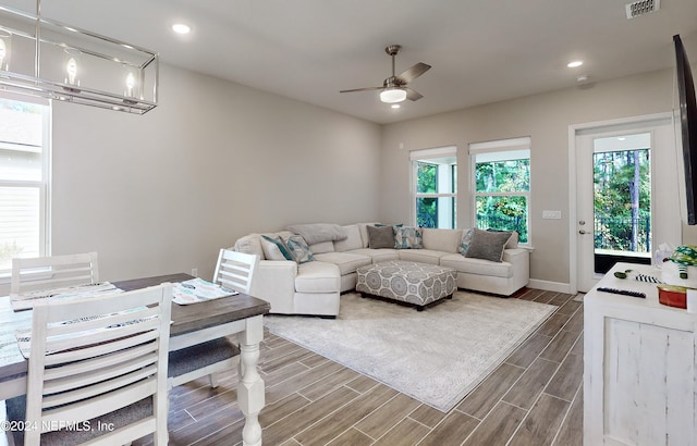 living room featuring a wealth of natural light, hardwood / wood-style floors, and ceiling fan