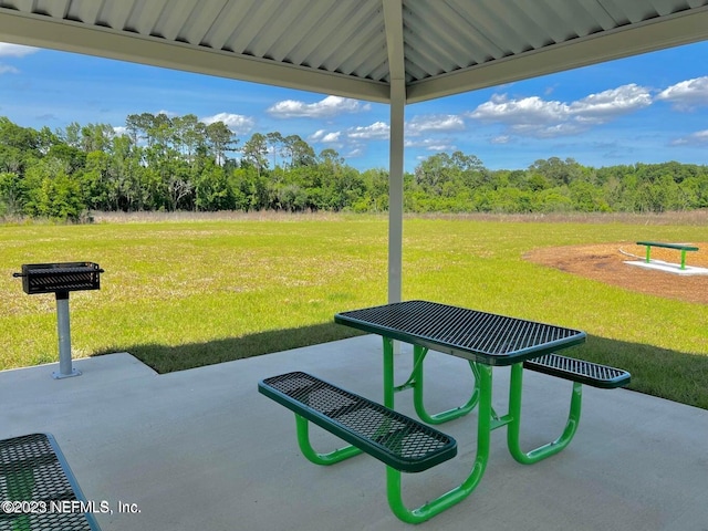 view of home's community featuring a patio area and a lawn