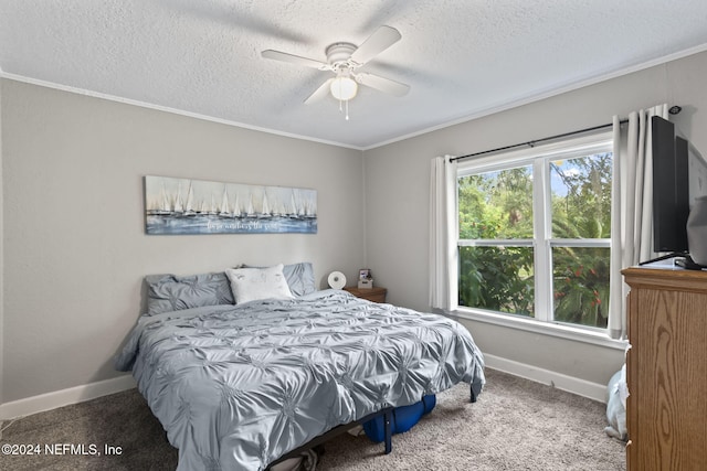 carpeted bedroom featuring ceiling fan, a textured ceiling, and crown molding