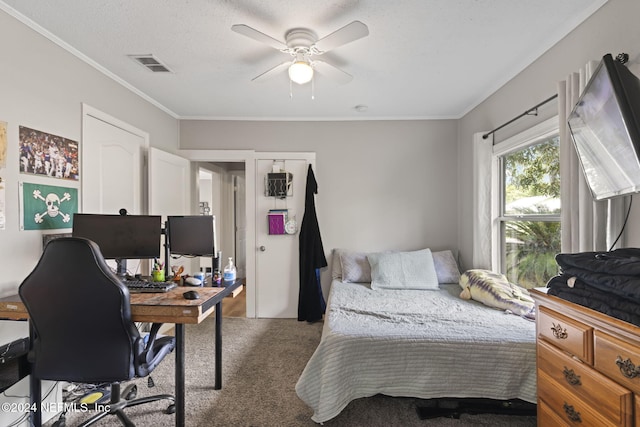 carpeted bedroom featuring a textured ceiling, ceiling fan, and crown molding