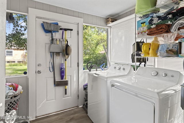 washroom featuring washing machine and dryer, plenty of natural light, dark hardwood / wood-style flooring, and ornamental molding