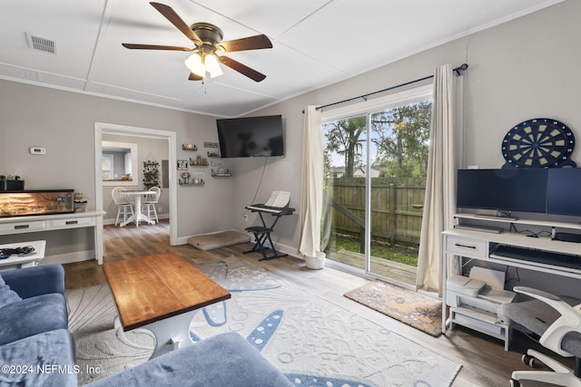 living room with hardwood / wood-style flooring, ceiling fan, and crown molding