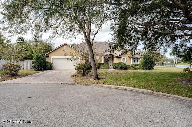 single story home with a garage and a front yard