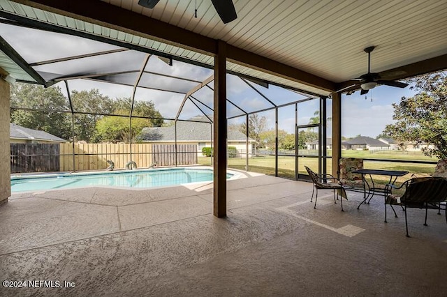 view of swimming pool featuring ceiling fan, a lanai, and a patio