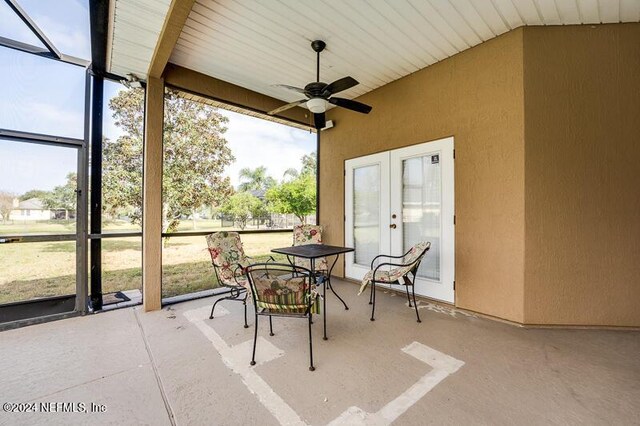 sunroom featuring a wealth of natural light, ceiling fan, and french doors