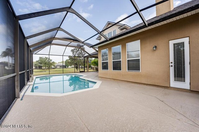 view of pool with a lanai and a patio area