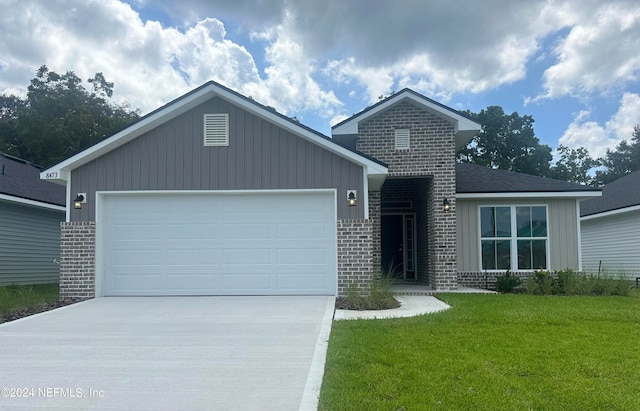 view of front of home with a garage and a front yard