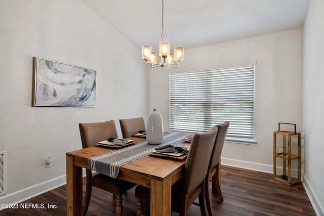 dining room featuring dark hardwood / wood-style floors and an inviting chandelier