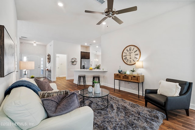 living room featuring ceiling fan and dark hardwood / wood-style floors