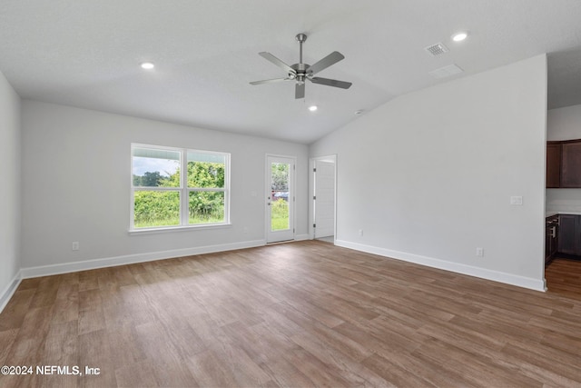 spare room featuring ceiling fan, light hardwood / wood-style flooring, and vaulted ceiling