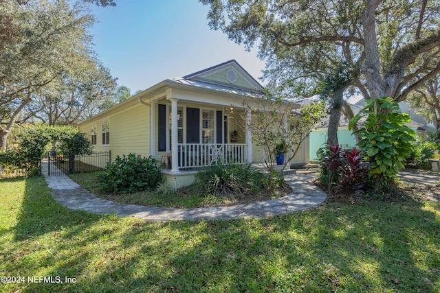 view of front of house with a porch and a front lawn