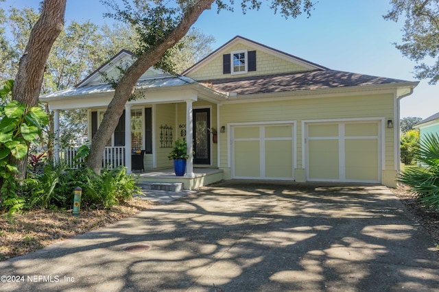 view of front of property with a garage and covered porch