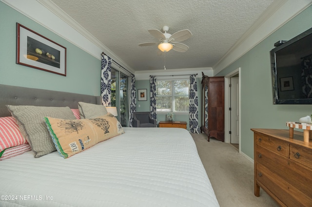 bedroom featuring ceiling fan, a textured ceiling, crown molding, and light colored carpet