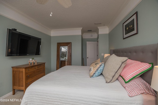 carpeted bedroom with a textured ceiling, ceiling fan, and crown molding