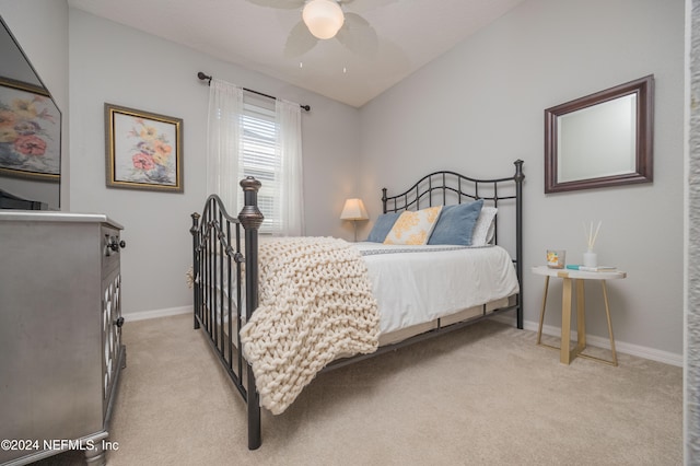 bedroom with ceiling fan and light colored carpet