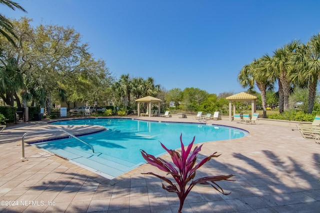 view of swimming pool featuring a patio area and a gazebo