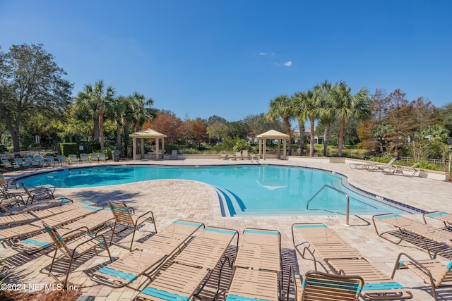 view of swimming pool featuring a patio area and a gazebo