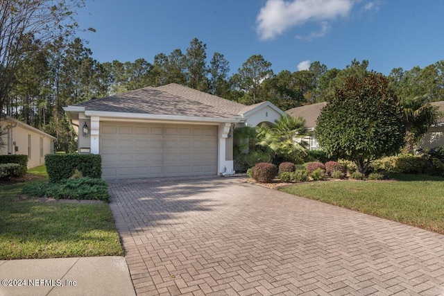 ranch-style house featuring a garage and a front yard