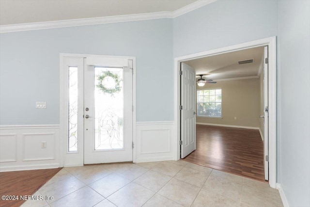 foyer with ceiling fan, light hardwood / wood-style flooring, and crown molding