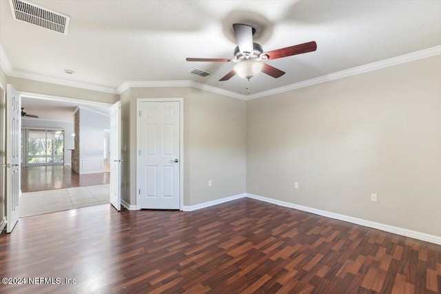 empty room with ornamental molding, dark hardwood / wood-style floors, and ceiling fan