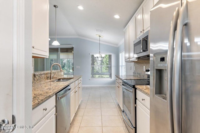 kitchen with white cabinetry, lofted ceiling, sink, and stainless steel appliances