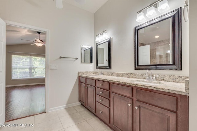 bathroom with vanity, wood-type flooring, vaulted ceiling, and ceiling fan