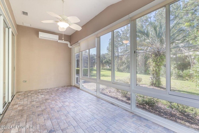 unfurnished sunroom with plenty of natural light, an AC wall unit, and ceiling fan