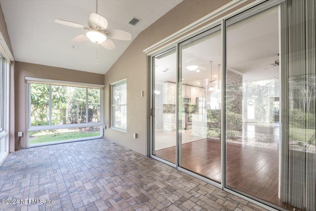 unfurnished sunroom featuring vaulted ceiling and ceiling fan