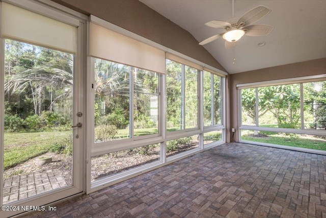 unfurnished sunroom with lofted ceiling and ceiling fan