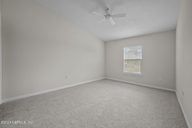 carpeted spare room with a textured ceiling and ceiling fan