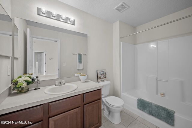 full bathroom featuring bathing tub / shower combination, a textured ceiling, vanity, tile patterned floors, and toilet