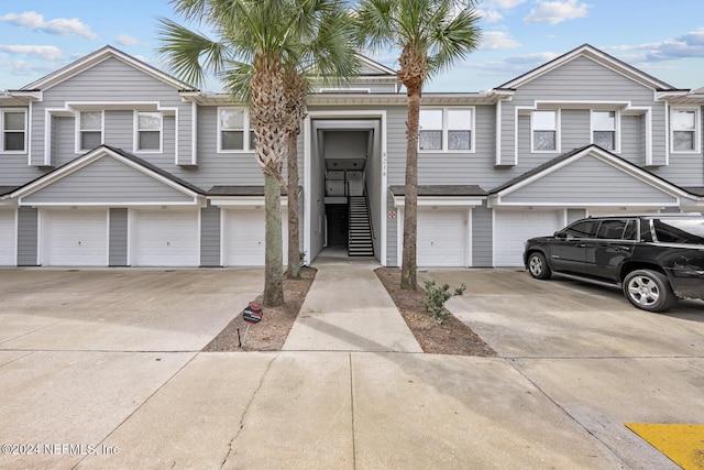 multi unit property featuring a garage