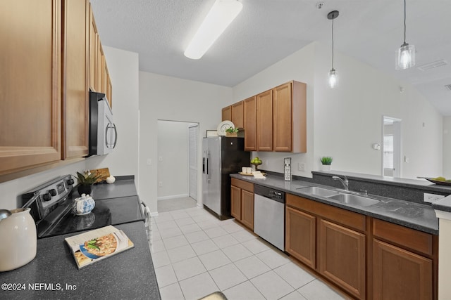 kitchen with appliances with stainless steel finishes, decorative light fixtures, light tile patterned floors, sink, and lofted ceiling