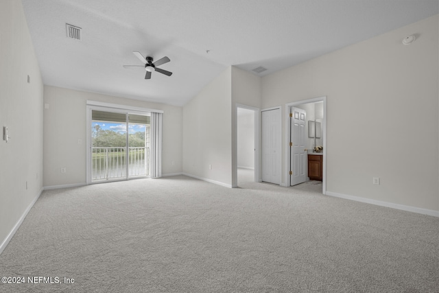 empty room featuring ceiling fan, lofted ceiling, and light colored carpet