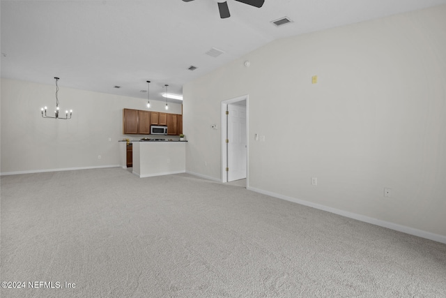 unfurnished living room with ceiling fan with notable chandelier, light colored carpet, and lofted ceiling