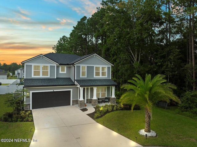 view of front facade featuring a garage and a lawn