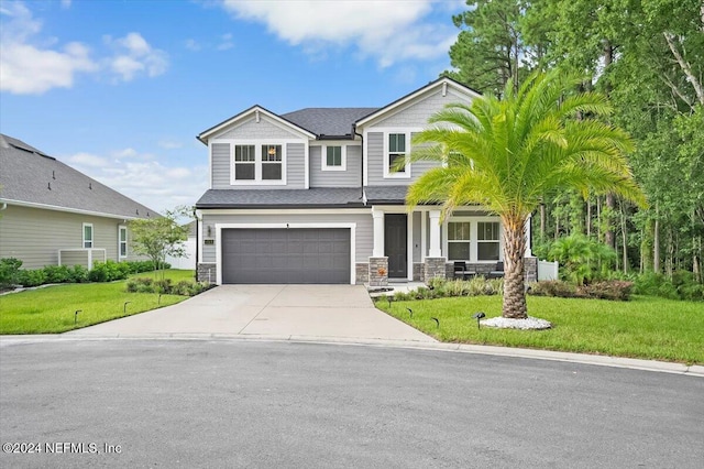 view of front of property featuring a front yard and a garage