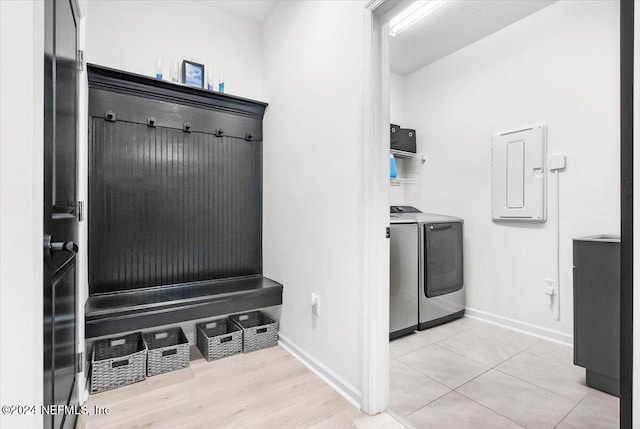 mudroom with electric panel, light hardwood / wood-style flooring, and washer and clothes dryer