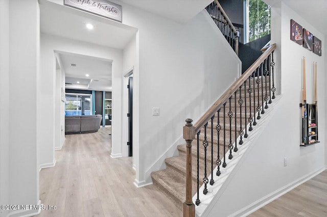 staircase with hardwood / wood-style flooring