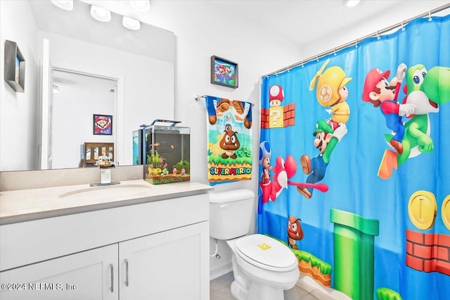 bathroom with toilet, a shower with curtain, vanity, and tile patterned floors