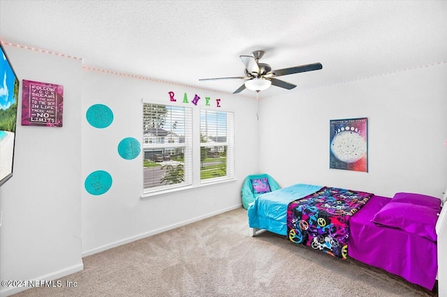 bedroom with carpet, a textured ceiling, and ceiling fan