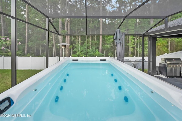 view of pool featuring a lanai and grilling area