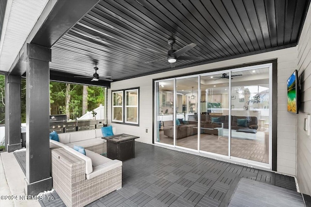 view of patio / terrace featuring ceiling fan and exterior kitchen