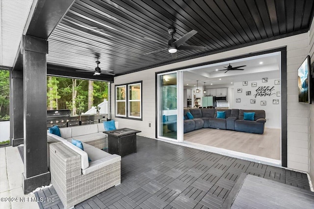 view of patio with area for grilling and ceiling fan