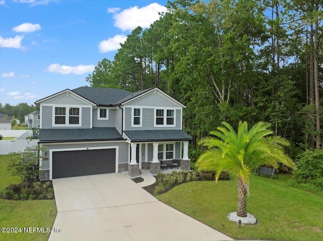 view of front of house with a front lawn and a garage