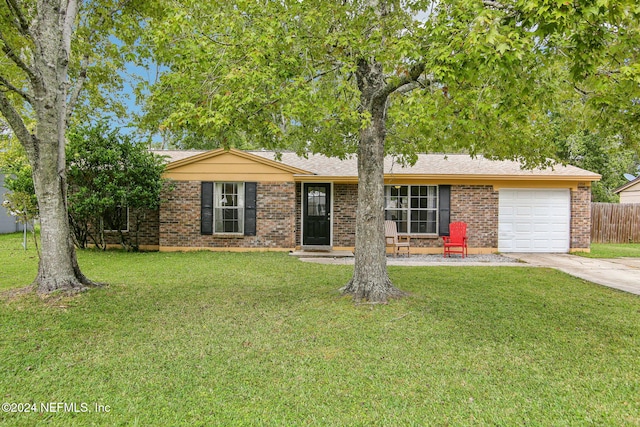 ranch-style house featuring a garage and a front yard