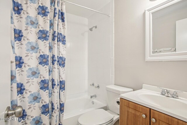 full bathroom with toilet, shower / tub combo, and vanity